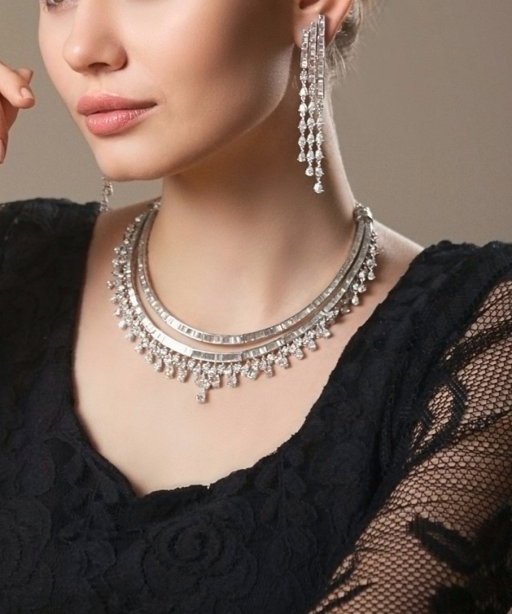 Baguette diamond collar necklace with matching tassel earrings, worn